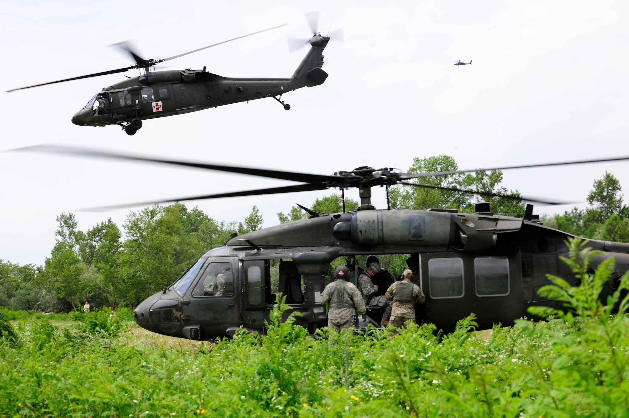 Participants in a combat search and rescue training mission board a U.S. Army UH-60 Black Hawk helicopter, June 24, 2014, at Cellina Meduna training grounds near Maniago, Italy. Soldiers and Airmen worked hand-in-hand to ensure rescued “patients” received proper medical attention. (U.S. Air Force photo/Airman 1st Class Ryan Conroy) 