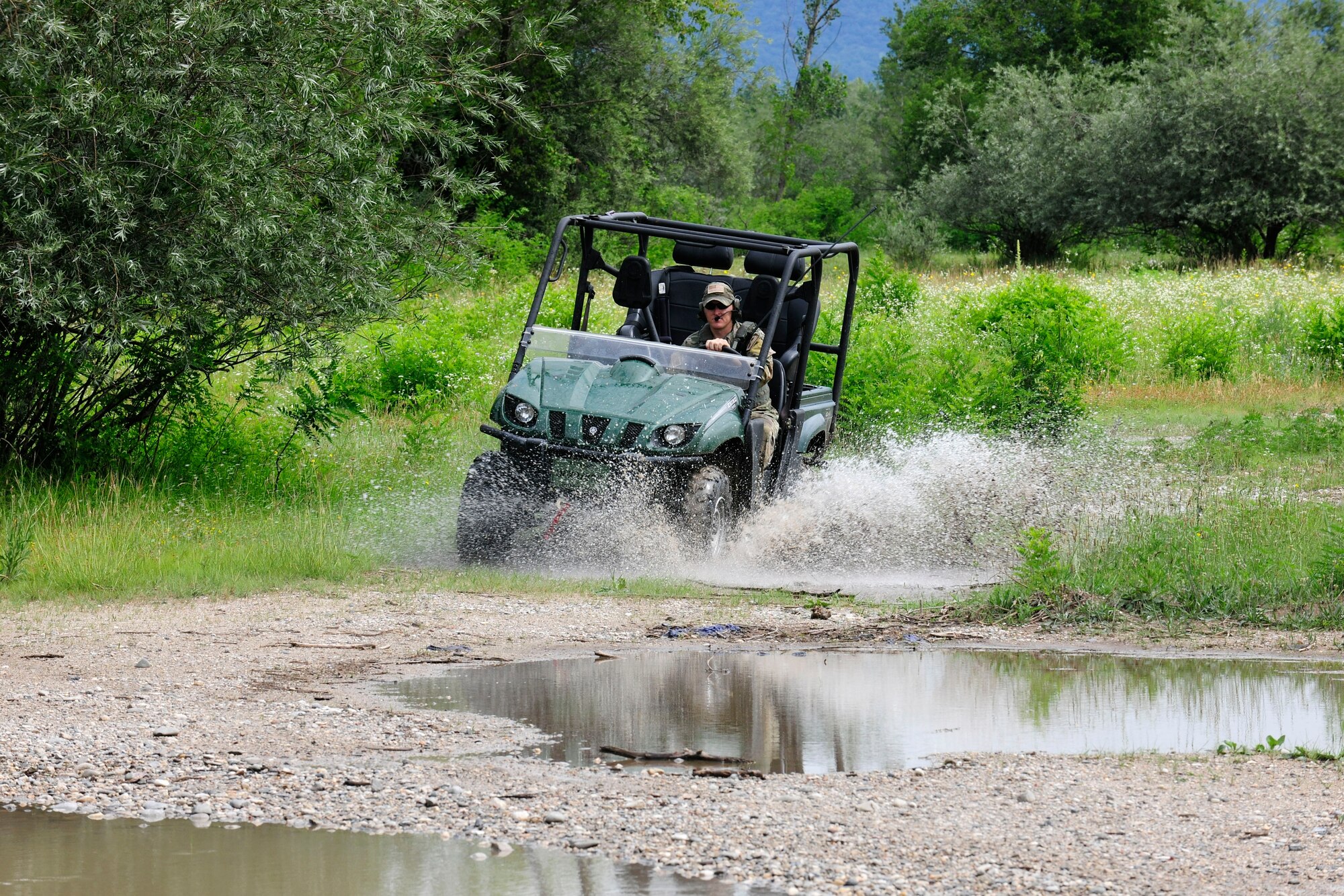 U.S. Air Force Staff Sgt. Claude Brown, 31st Operations Support Squadron Survival, Evasion, Resistance and Escape specialist, serves as an “opposing force” in an all-terrain vehicle during a combat search and rescue training mission, June 24, 2014, at Cellina Meduna training grounds near Maniago, Italy. Opposing ground forces consisting of four vehicles and 20 personnel were involved and served as dynamic targets for air assets to engage. (U.S. Air Force photo/Airman 1st Class Ryan Conroy) 