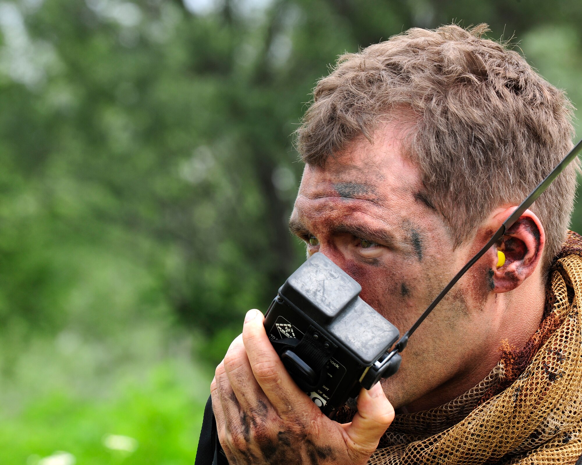 U.S. Air Force Capt. William Flynt, 555th Fighter Squadron pilot, attempts to make radio contact with aircrew searching for him during a combat search and rescue training mission, June 24, 2014, at Cellina Meduna training ground near Maniago, Italy. Pilots are taught necessary survival skills to evade capture and get recovered successfully to include: movement, camouflage and signaling techniques. (U.S. Air Force photo/Airman 1st Class Ryan Conroy)