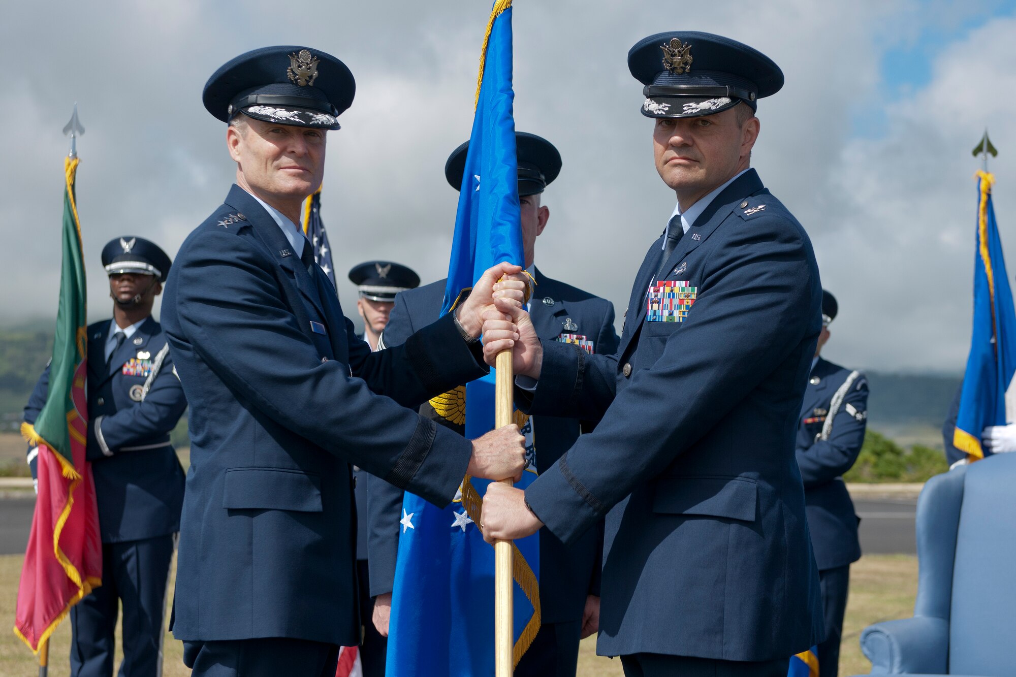 Lt. Gen. Darryl Roberson, 3rd Air Force commander, passes the 65th Air Base Wing guidon to Col. Martin Rothrock, 65th ABW commander, during a change of command ceremony June 26, Lajes Field, Azores, Portugal.  Rothrock assumed command from Col. Chris Bargery, who had commanded the 65th ABW since July 2012.  Rothrock is a career security forces officer and arrives at Lajes Field from United States Forces in Korea.  (U.S. Air Force photo by Tech. Sgt. Paul Villanueva II/Released)