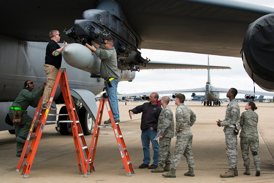 Weapons loaders assigned to the 307th Aircraft Maintenance Squadron finish installing a simulated AN/ASQ-236 Radar Pod on a 93rd Bomb Squadron B-52H Stratofortress, April 7, 2014, Barksdale Air Force Base, Louisiana. The pod is the length and weight of the actual AN/ASQ-236, and the installation was to test loading procedures on a B-52. (U.S. Air Force photo by Master Sgt. Greg Steele/Released)