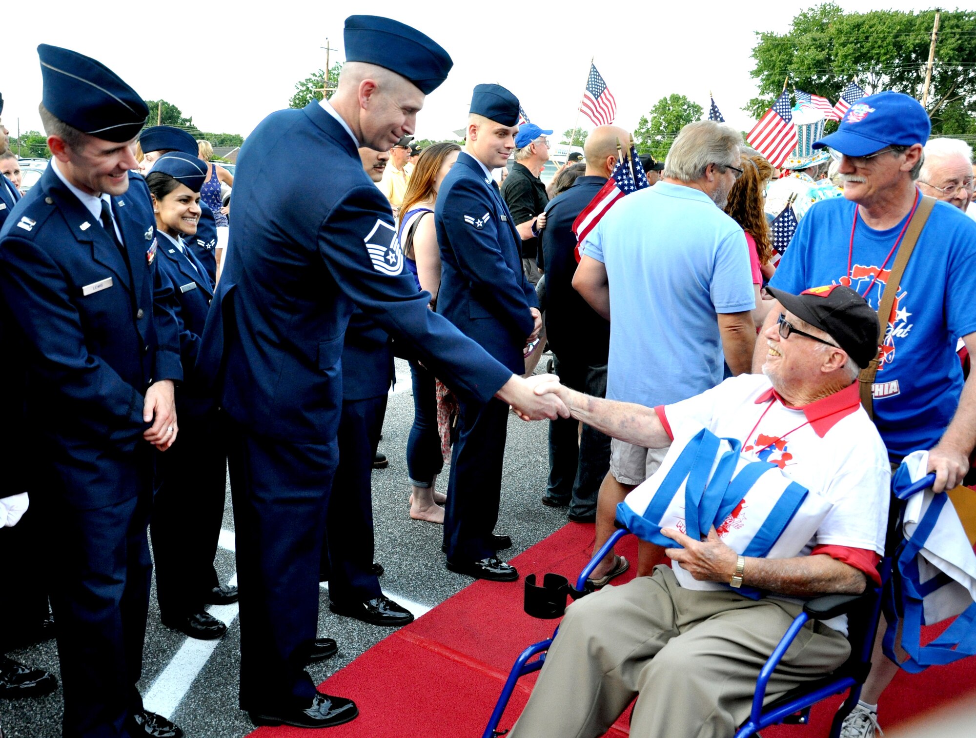 Master Sgt. John Haynes, 305th Aerial Port Squadron cargo processing chief, shakes the hand of a veteran during Honor Flight Philadelphia’s welcome reception June 21, 2014, at St. Kevin’s Church, Springfield, Pa.  Honor Flight Philadelphia escorted more than 150 World War II and Korean War veterans to the nation’s capital and to Arlington National Cemetery, Va.  Upon their return, they were greeted by more than 700 people outside of the church, including service members from Joint Base McGuire-Dix-Lakehurst, N.J. Haynes hails from Cedar Springs, Mich. (U.S. Air Force photo by 2nd Lt. Carrie Volpe/Released)