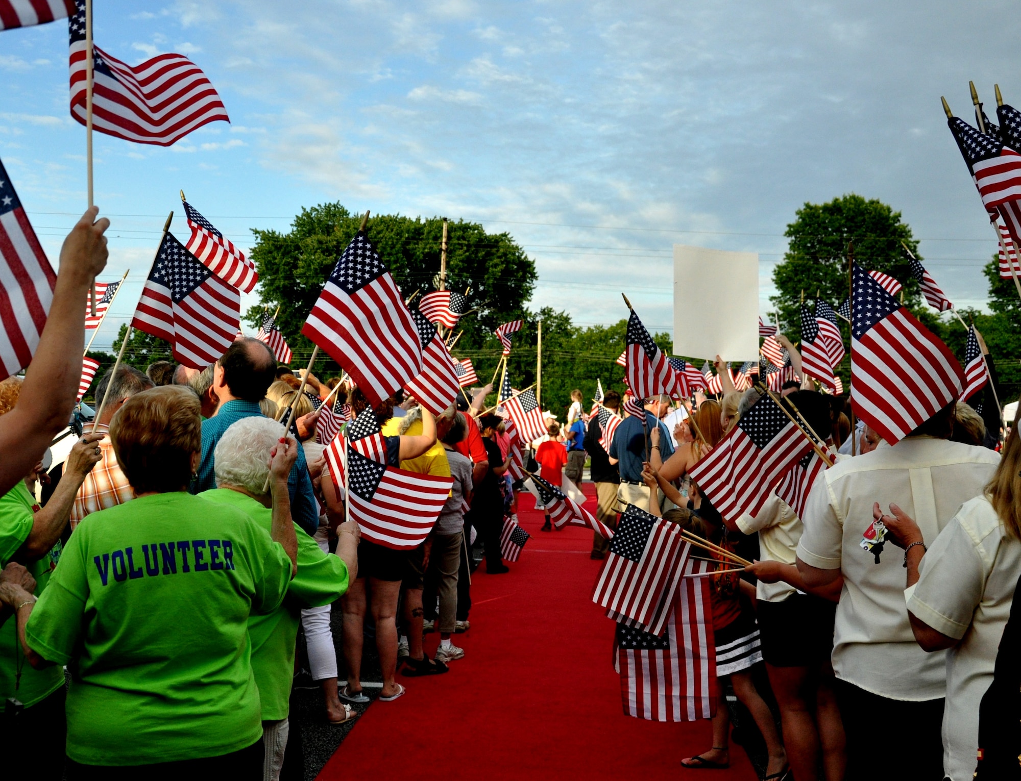 A crowd of more than 700, comprised of families, friends, service members, community members and volunteers, line up along a red carpet as they awaited the arrival of more than 150 World War II and Korean War veterans upon their return from visiting the nation’s capital, June 21, 2014, at St. Kevin’s Church, Springfield, Pa. Service members from Joint Base McGuire-Dix-Lakehurst, N.J., traveled to Pennsylvania to participate in the veterans’ welcome reception.(U.S. Air Force photo by 2nd Lt. Carrie Volpe/Released)