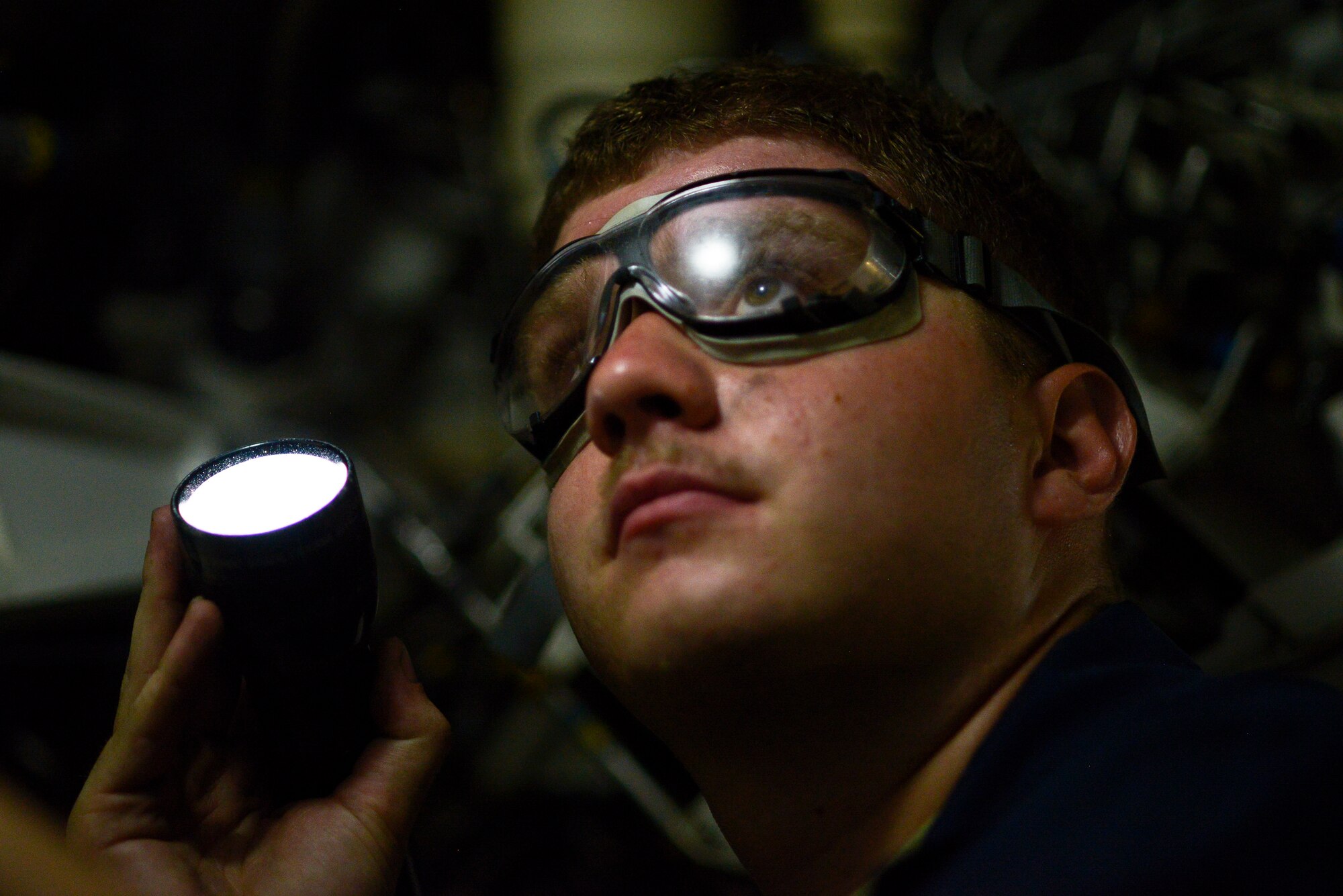 Senior Airman Patrick Mooneyham, an assistant dedicated crew chief deployed from Joint Base Langley-Eustis, Va., verifies the pressure in a stored energy system on an F-22A Raptor June 17, 2014, at an undisclosed location in Southwest Asia. The system is one of the components used to start the aircraft. (U.S. Air Force photo by Tech. Sgt. Russ Scalf/Released)