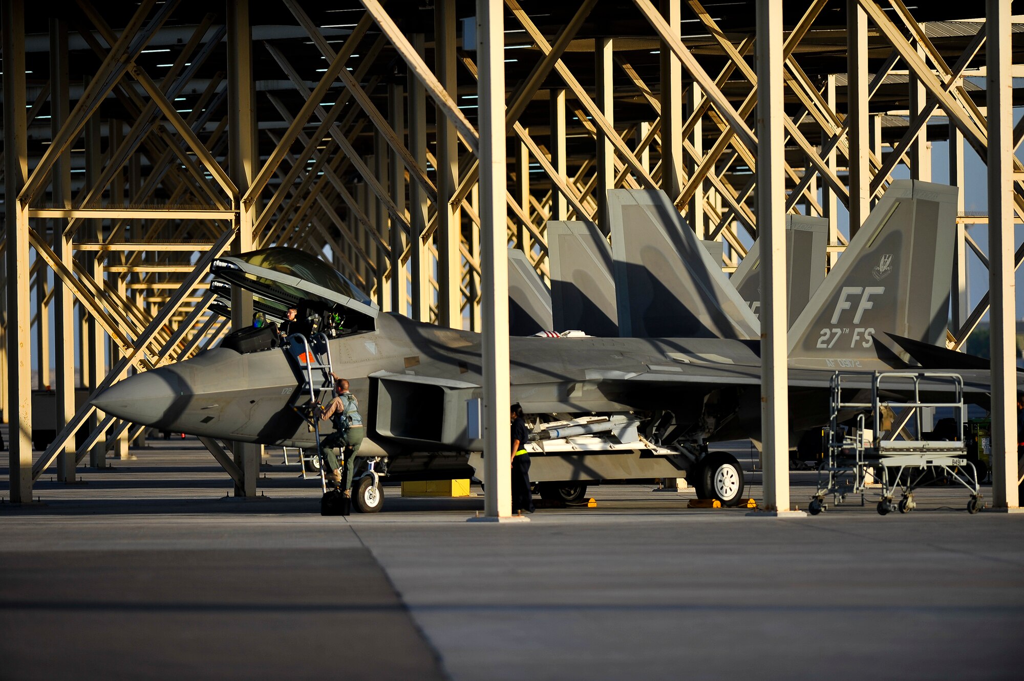 Lt. Col. David Elliot, 27th Expeditionary Fighter Squadron commander, climbs into an F-22A Raptor June 17, 2014, at an undisclosed location in Southwest Asia. The F-22’s combination of stealth, supercruise, maneuverability, and integrated avionics coupled with improved supportability represents an exponential leap in warfighting capabilities. (U.S. Air Force photo by Tech. Sgt. Russ Scalf/Released)