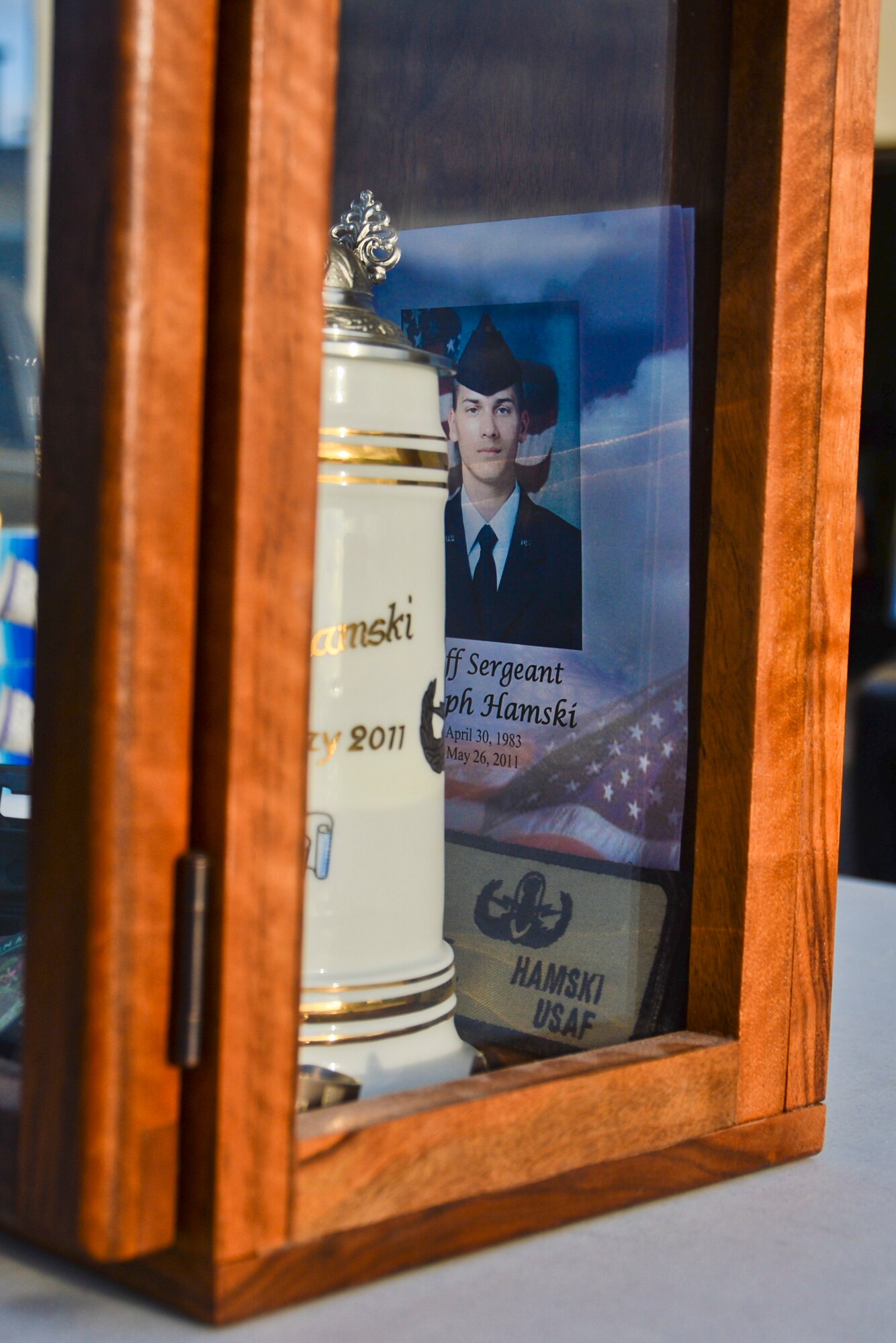 A memorial case for U.S. Air Force Staff Sgt. Joseph Hamski, formerly assigned to the 52nd Civil Engineer Squadron explosive ordnance disposal flight, rests on a table before the Jog for Joe Memorial 5K at the base track at Spangdahlem Air Base, Germany, June 20, 2014. The 52nd CES EOD flight organized the run to honor legacy of Hamski, who was killed in support of Operation Enduring Freedom May 26, 2011. (U.S. Air Force photo by Staff Sgt. Joe W. McFadden/Released)