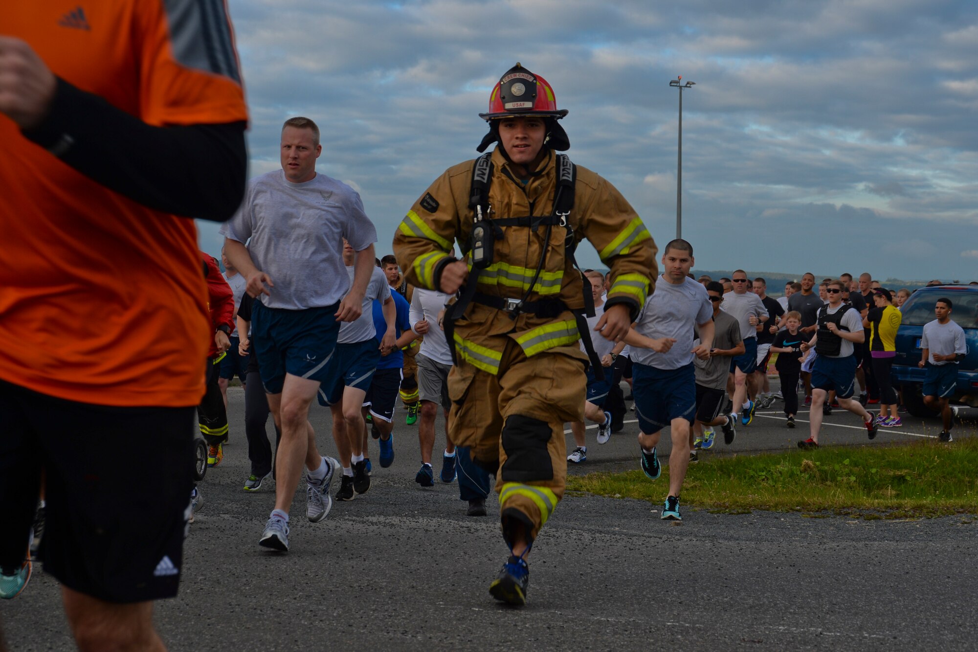U.S. Air Force Staff Sgt. Bryan Souder, a firefighter assigned to the 52nd Civil Engineer Squadron and Bellevue, Neb., native, runs beside fellow participants in the Jog for Joe Memorial 5K at the base track at Spangdahlem Air Base, Germany, June 20, 2014. Nearly 500 Airmen and their families participated in the run to commemorate the loss of Staff Sgt. Joseph Hamski, a 52nd CES explosive ordnance disposal flight technician, who was killed in support of Operation Enduring Freedom May 26, 2011. (U.S. Air Force photo by Staff Sgt. Joe W. McFadden/Released)