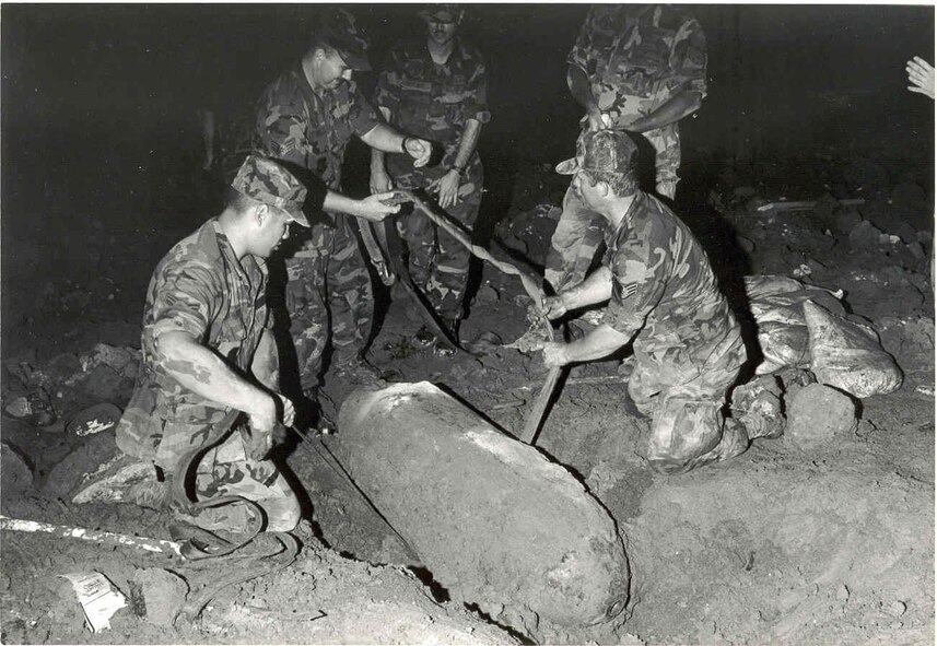 Airmen of the 432d Civil Engineer Squadron prepare a World War II-era, M-65 bomb for removal from the construction site of the new base hospital at Misawa Air Base on July 29, 1991.  (U.S. Air Force historical photo)