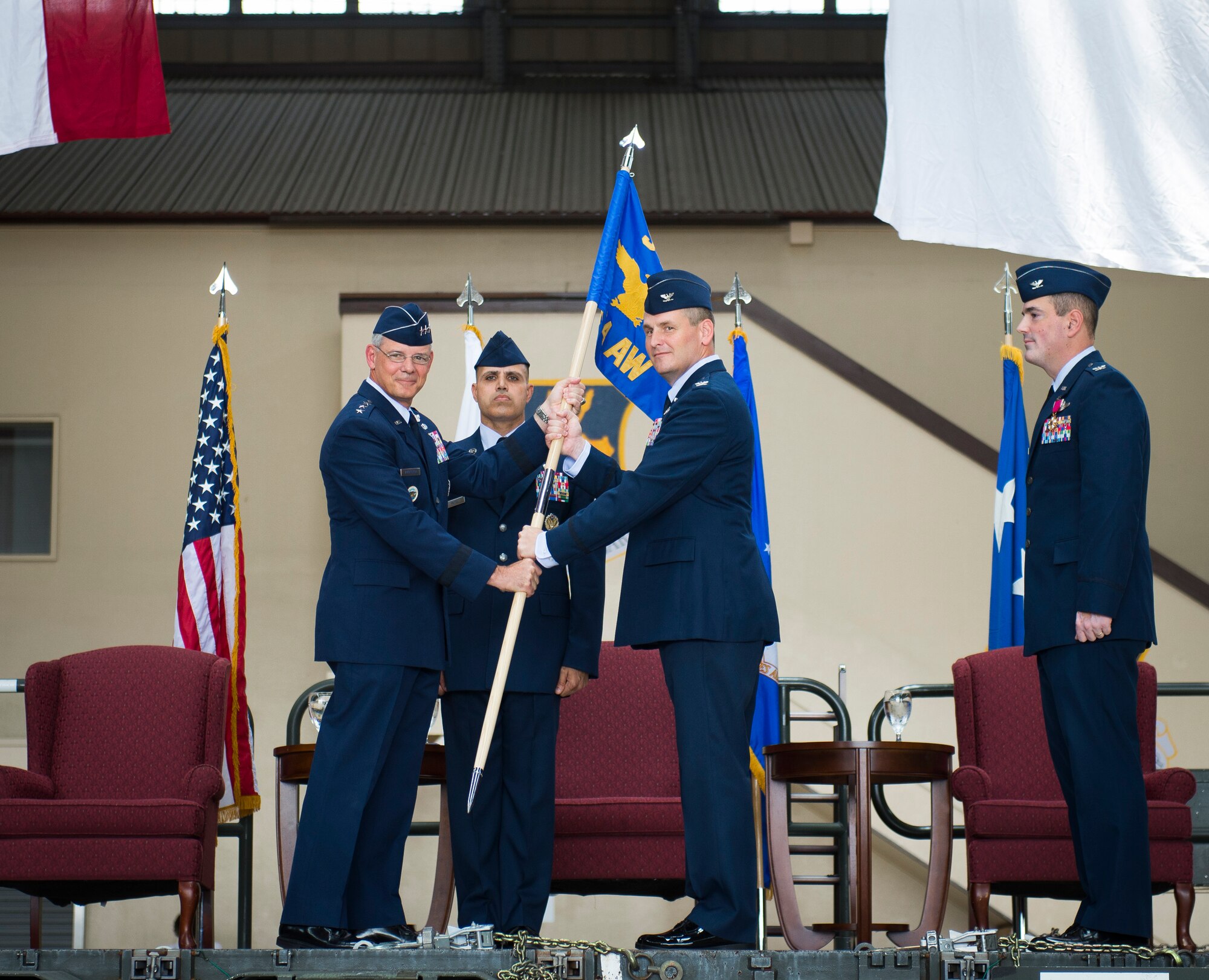 Lt. Gen. Salvatore Angelella, U.S. Forces Japan, and 5th Air Force commander, passes the wing guidon to the new 374th Airlift Wing commander, Col. Douglas DeLaMater during the 374th Airlift Wing change of command ceremony at Yokota Air Base, Japan, June 26, 2014. (U.S. Air Force photo by Staff Sgt. Chad C. Strohmeyer/Released)