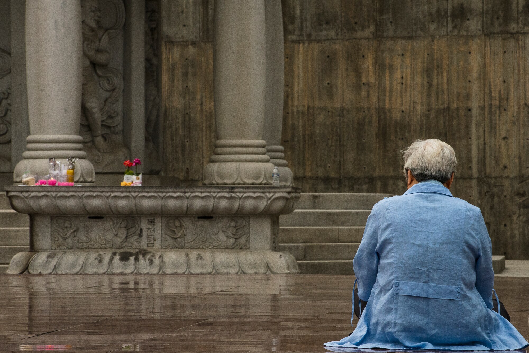 A supplicant prays at Bonguensa Temple May 24, 2014, in Seoul, Republic of Korea. The temple is open year round and located next to the COEX shopping mall in Seoul. (U.S. Air Force photo by Staff Sgt. Jake Barreiro)