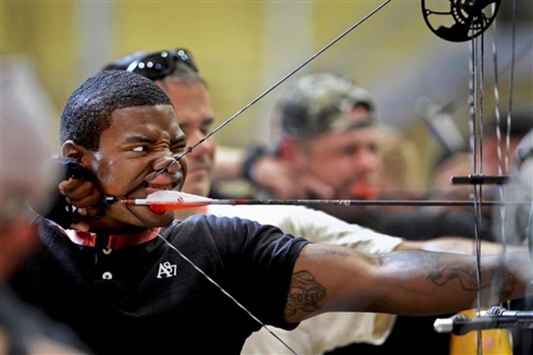 Army Spc. James Michael Taylor Jr. takes aim as he competes in the archery competition during Warrior Games trials at the U.S. Military Academy at West Point, N.Y., June 18, 2014. More than 100 military athletes competed in archery, cycling, shooting, sitting volleyball, swimming, track and field, and wheelchair basketball tournaments to represent their service in the 2014 Warrior Games competition in Colorado Springs, Colo. 