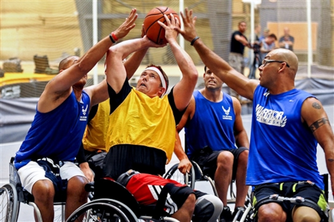 Army Master Sgt. Daniel Hendrix, center, fights for a rebound against the Air Force team in wheelchair basketball during Warrior Games trials at the U.S. Military Academy at West Point, N.Y., June 16, 2014. 