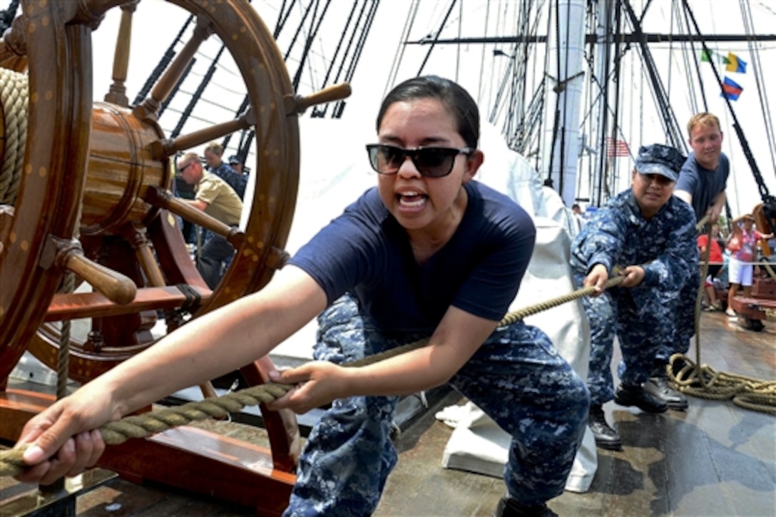 Navy Seaman Amada Williamson heaves on a line connected to the mizzenmast topsail aboard USS Constitution in Charlestown, Mass., June 17, 2014. Constitution sailors train during spring and summer months to learn seamanship techniques used aboard Old Ironsides since the 1790s. 