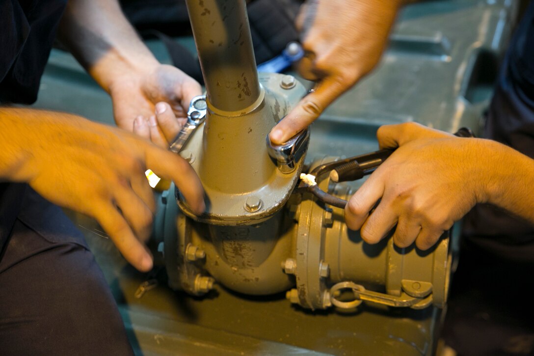 Marines repair a water valve June 18 on Camp Hansen during a mobility exercise to test the Marines on their response time in case they are needed for a deployment. The Marines are with Bulk Fuel Company, 9th Engineer Support Battalion, 3rd Marine Logistics Group, III Marine Expeditionary Force.