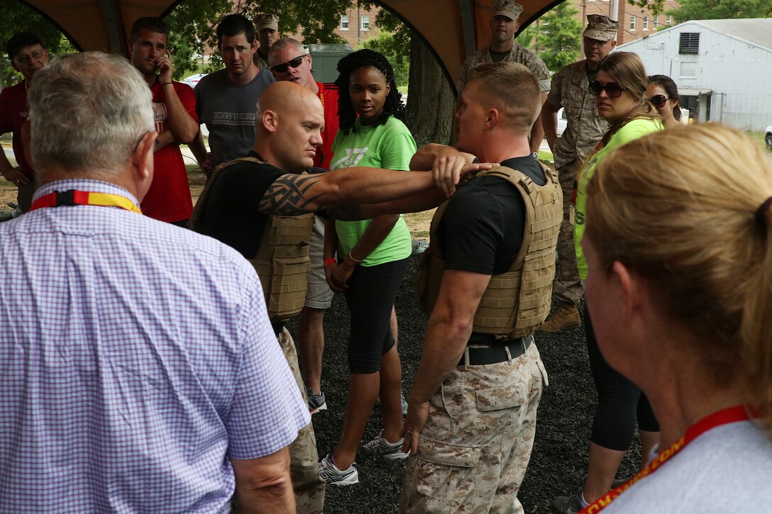 Marine Corps Martial Arts Instructor Trainers demonstrate self-defense maneuvers during a visit from Educators and Key Leaders Workshop attendees at Marine Corps Base Quantico, Va., June 24, 2014. Guests observe different techniques that come with degrees of belts as they become increasingly complex. The Educators and Key Leaders Workshop exposes college professors and community leaders to the myriad career opportunities the Marine Corps offers, specifically geared toward officer commissioning programs.

