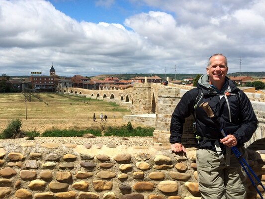 Barney Schulte, a structural engineer in the U.S. Army Corps of Engineers Nashville District, poses by the Puente de Orbigo, a medieval 13th century bridge, which is over the Rio Orbigo in Hospital de Orbigo, Spain.  One of the longest medieval bridges in Spain, it was built over an earlier Roman bridge.  The jousting area next to the bridge is the site of a famous tournament that took place there in 1434.  Schulte visited this landmark during his 490-mile pilgrimage of Camino de Santiago, an ancient path that Christians retrace for spiritual renewal.