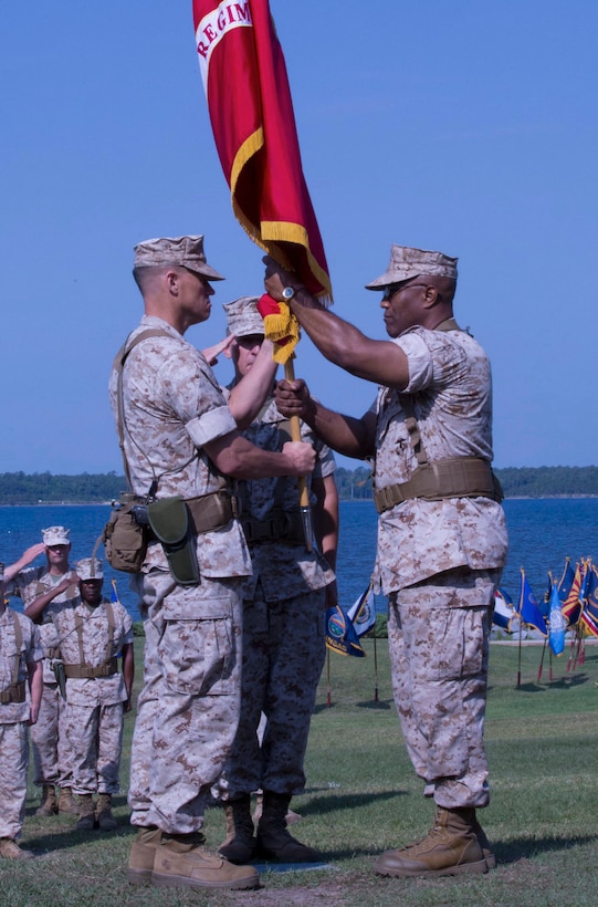 Col. Wolford (left), the new commanding officer, accepts the regimental colors for Combat Logistics Regiment 2, 2nd Marine Logistics Group from Col. Whiteside during a change of command ceremony aboard Camp Lejeune, N.C.,  June 18.  Whiteside commanded CLR-2 for nearly two years.
