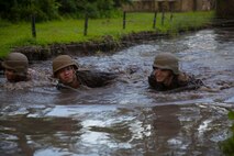 Marine noncommissioned officers with 2nd Supply Battalion, Combat Logistics Regiment 25, 2nd Marine Logistics Group crawl through a water-filled trench beneath barbed wire during an endurance course aboard Camp Lejeune, N.C., June 26, 2014. Water-based obstacles differentiated the endurance course from others the Marines may have faced during their careers and provided additional challenges. 