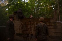 Marines with 2nd Supply Battalion, Combat Logistics Regiment 25, 2nd Marine Logistics Group climb a low wall during an endurance course aboard Camp Lejeune, N.C., June 26, 2014. The event gave noncommissioned officers with the unit a way to become a tighter group while building trust and confidence in themselves and each other through adversity.