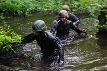 Marines with 2nd Supply Battalion, Combat Logistics Regiment 25, 2nd Marine Logistics Group wade through muddy water during an endurance course aboard Camp Lejeune, N.C., June 26, 2014. The added weight of soaked uniforms provided a greater challenge for the unit’s noncommissioned officers during the course. 