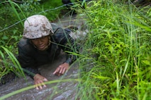 A Marine with 2nd Supply Battalion, Combat Logistics Regiment 25, 2nd Marine Logistics Group crawls through mud and water during an endurance course aboard Camp Lejeune, N.C., June 26, 2014. The course tested the Marines’ fortitude and leadership while strengthening camaraderie. 