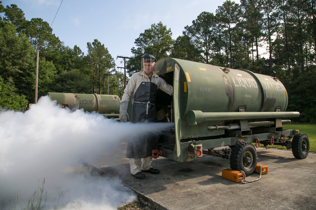 Lance Cpl. Kieth McGaha, a cryogenics technician with Marine Aviation Logistics Squadron 31, drains a liquid oxygen tank at the Cryogenics Facility aboard Marine Corps Air Station Beaufort, June 24. Cryogenics Marines must empty the tanks prior to replacing it's gauges.Cryogenics technicians use a large machine called an oxygen/nitrogen generating plant that isolates the two useful gasses from the air and chills them to their liquid form. Oxygen is used to supply aircraft with breathable air for pilots, crew members and passengers. Nitrogen is used in multiple areas of aircraft including the canopy, tires, struts and more.