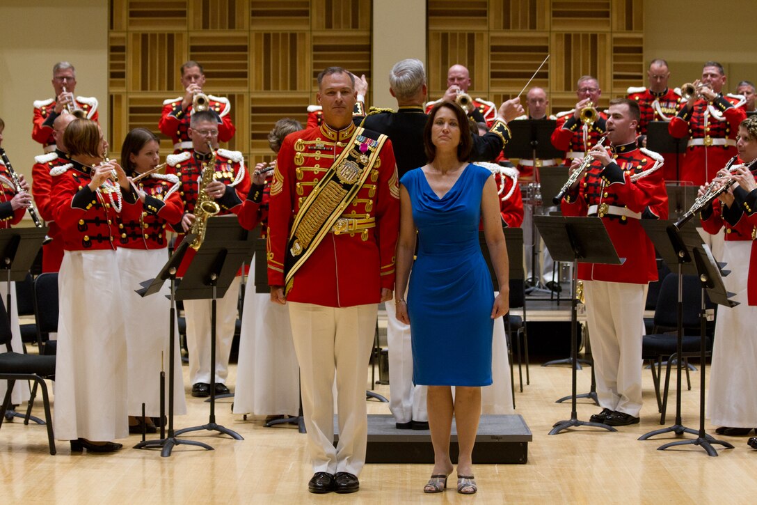 On June 26, 2014, the Marine Band conducted a Drum Major relief and appointment ceremony, officiated by Director Col. Michael J. Colburn in the John Philip Sousa Band Hall at Marine Barracks Washington, D.C. Drum Major Master Gunnery Sgt. William L. Browne was relieved by Gunnery Sgt. Duane F. King, making him the 40th Drum Major of “The President’s Own.” Immediately following the ceremony, Browne retired after 25 years in the Marine Corps. His retirement ceremony was officiated by the 35th Commandant of the Marine Corps, General James F. Amos. Drum Major Browne stands at attention for The Marines' Hymn with his wife Shawna, a former Marine. 