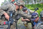 A medic with Charlie Company, 1st Battalion, 102nd Infantry Regiment, renders aid to a police chief during a simulated chemical attack as part of training, June 18, 2014 at Fort Polk, La. The Vermont Army National Guard’s 86th Infantry Brigade Combat Team (Mountain) is in the middle its Decisive Action Training Environment rotation at the Joint Readiness Training Center at Fort Polk, and is the first and only National Guard unit to take part in a rotation at JRTC this year.