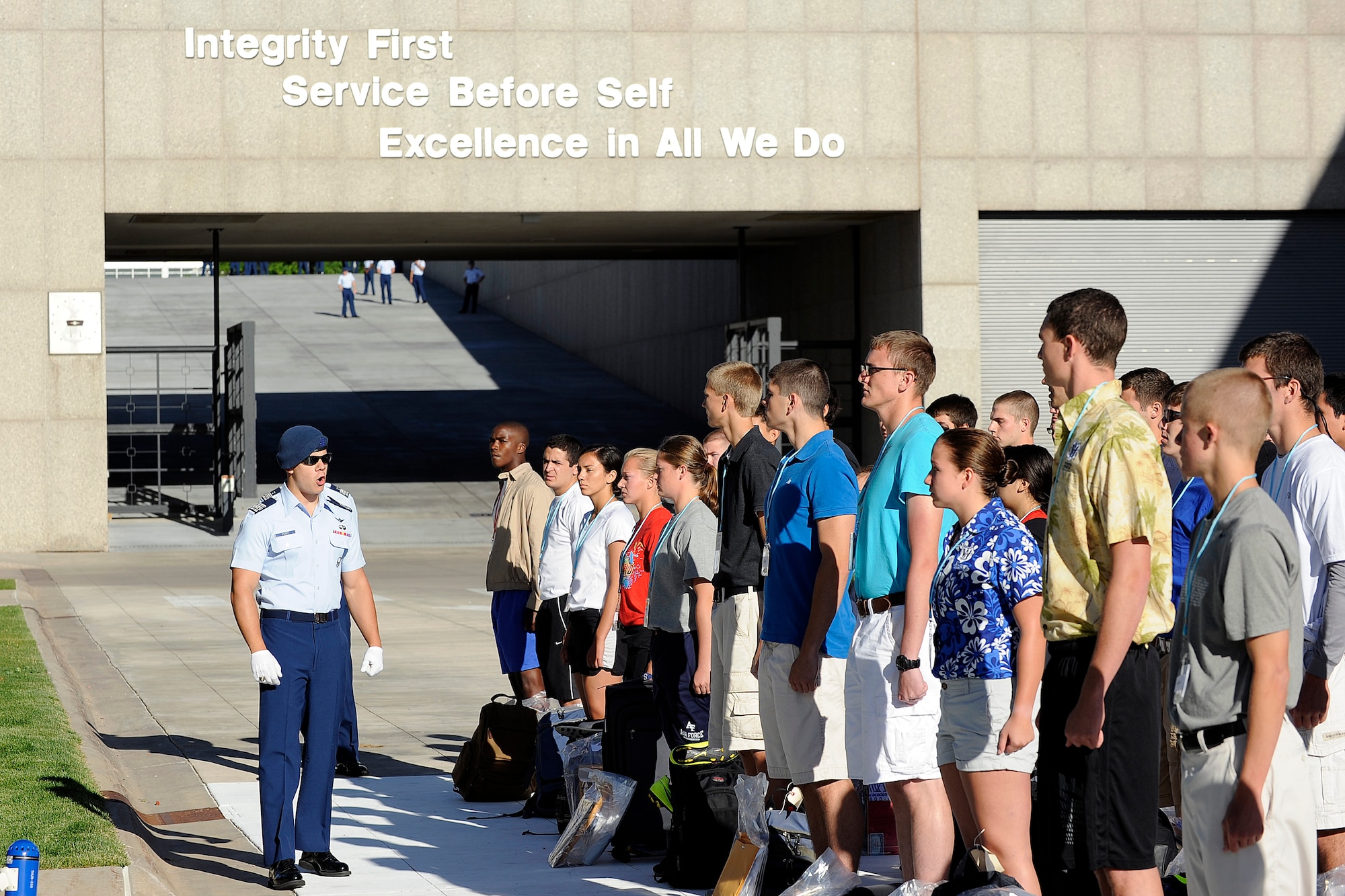 Basic cadets from the Class of 2018 are addressed by cadet cadre as they stand in formation June 26, 2014, on "the footsteps" outside of the Core Values Ramp at the U.S. Air Force Academy, Colo. Basic cadets spent their first day getting a military haircut and their uniforms, donating blood, meeting their cadre, and receiving a taste of Academy life. (U.S. Air Force Photo/Sarah Chambers)