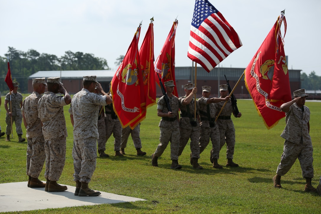 Sergeant Maj. Thomas A. Hall Jr., (left), former sergeant major of U.S. Marine Corps Forces Special Operations Command, (MARSOC), Sgt. Maj. John W. Scott (middle), sergeant major of MARSOC, and Maj. Gen. Mark A. Clark (right), commander of MARSOC, salute the national ensign during a relief, appointment and retirement ceremony at Stone Bay, aboard Marine Corps Base Camp Lejeune, N.C., June 27.