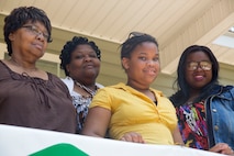Members of the Brimmer-George family stand on the porch of their new home built by Marines from Bravo Company, 8th Engineer Support Battalion, 2nd Marine Logistics Group and other volunteers in Newport, N.C., June 26, 2014. Marines with the unit used skills from their jobs in the Marine Corps to help build the home.