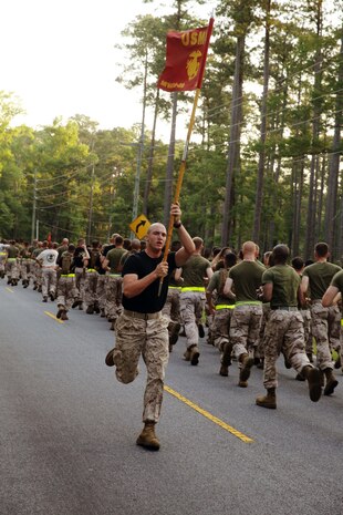 Lance Cpl. Peter D. Wilson runs with Company B's guidon during Marine Wing Communications Squadron 28's motivational run at Marine Corps Air Station Cherry Point, N.C., June 19, 2014. The squadron's run was the culminating event to the inaugural Spartan Cup. The Spartan Cup is a competition between the three companies within the squadron, evaluating each company's level of fitness, fighting spirit and commitment to Marine Corps values. Company B earned a place in the squadron's history as the first company to earn the Spartan Cup. The squadron plans to continue this ongoing competition crowning a winner semi-annually. Wilson is a field radio operator with Company B, MWCS-28.