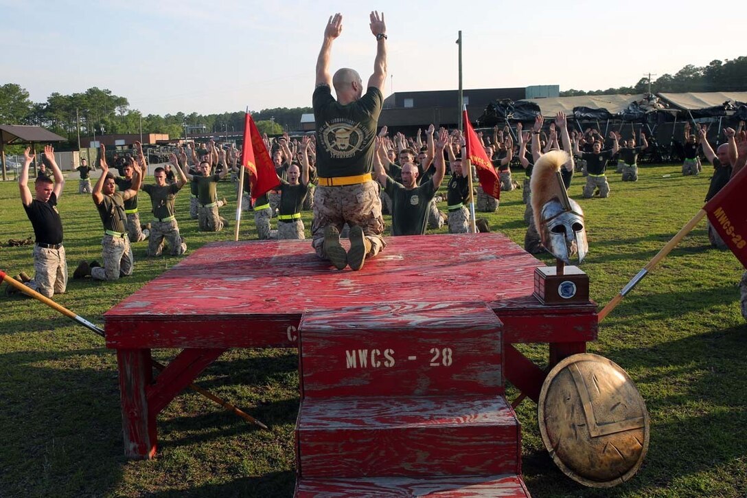 Sergeant Maj. Jason Green leads Marine Wing Communications Squadron 28 during cool down exercises after a motivational run at Marine Corps Air Station Cherry Point, N.C., June 19, 2014. The motivational run was the culminating event for squadron's inaugural Spartan Cup. The three companies of MWCS-28 competed in Spartan Cup, which helped the squadron achieve balanced excellence. The squadron plans to continue this ongoing competition crowning a winner semi-annually. Company B earned a place in the squadron's history as the first company to earn the Spartan Cup. Green is the squadron's sergeant major.