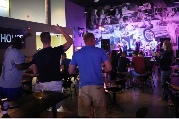 Residents of Marine Corps Air Station Cherry Point N.C., enjoy free entertainment from the Machine Gun Band at the Roadhouse June 26, 2014. The Roadhouse recently officially re-opened after eight months of renovations creating a completely new feel for the Marines and Sailors aboard the air station.