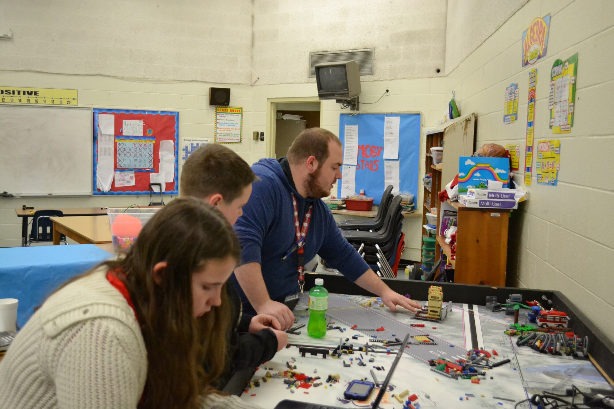 North Middle School teacher Kyle Reid (right) instructs North Middle School students on the plans for conducting the mission for the FIRST® Lego® League challenge.