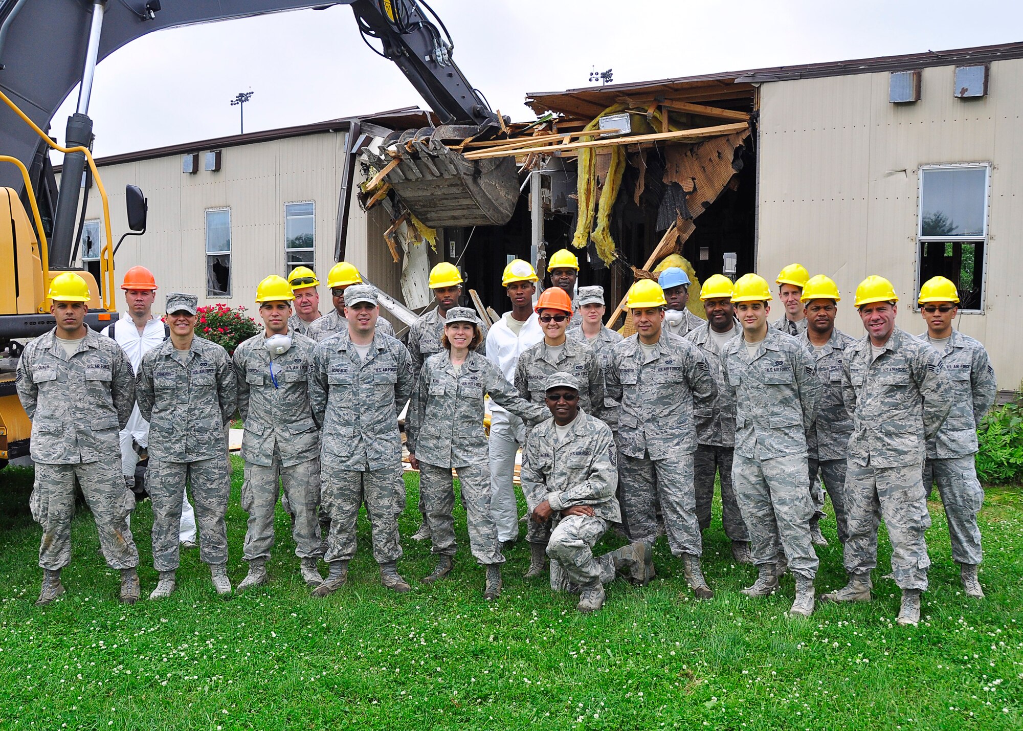 Col. Cynthia Wong, 514th Mission Support Group commander, poses with Airmen from 514th Civil Engineer Squadron in front of a trailer soon to be demolished as part of a 514th Air Mobility Wing self-help project.(Air Force photo/Christian DeLuca)