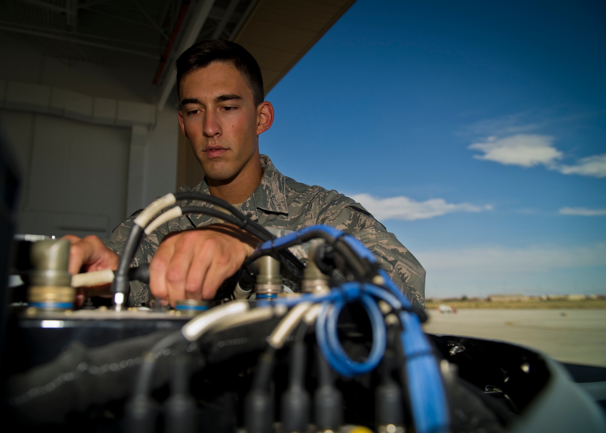 Senior Airman Aaron Feliciano, an avionics technician from the 49th Aircraft Maintenance Squadron, maintains an MQ-9 Reaper at Holloman Air Force Base, N.M., June 27.  Feliciano was recently selected as one of Air Combat Command’s six Outstanding Airmen of the Year for 2014.  Feliciano was hand-picked above many other qualified Airmen for his work performance, substantial self-improvement and significant community involvement. (U.S. Air Force photo by Airman 1st Class Aaron Montoya/Released)