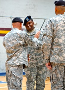 U.S. Army Sgt. Maj. Mathew Calhoun, 11th Transportation Battalion, 7th Transportation Brigade (Expeditionary) command sergeant major, receives the noncommissioned officers’ sword from Lt. Col. Karl Linderman, 11th Transportation Battalion, 7th Trans. Bde. (Ex), during a change of responsibility ceremony held at Fort Story, Va., June 20, 2014.  The passing of the noncommissioned officers’ sword represents a symbol of position and responsibility over an entire unit.  (U.S. Army photo by Sgt. Stefanie Warner/Released)