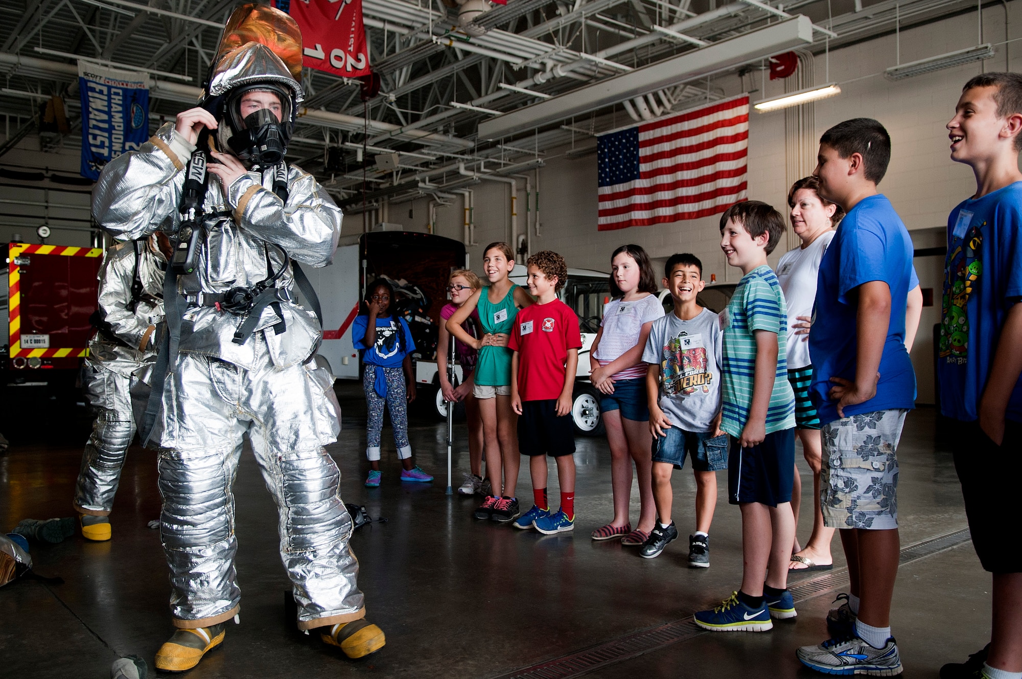Airman 1st Class Colin Filmore, 4th Civil Engineer Squadron firefighter, puts on his full fire suit for the students from Seymour Johnson’s Science and Technology Academies Reinforcing Basic Aviation and Space Exploration (STARBASE) program, June 24, 2014, at Seymour Johnson Air Force Base, North Carolina. STARBASE is a collaborative effort between the base and the surrounding community to promote education and innovation. During the five-day program, local fifth-grade students study science, technology, engineering and mathematics disciplines beyond their current grade level. (U.S. Air Force photo/Airman 1st Class Shawna L. Keyes)