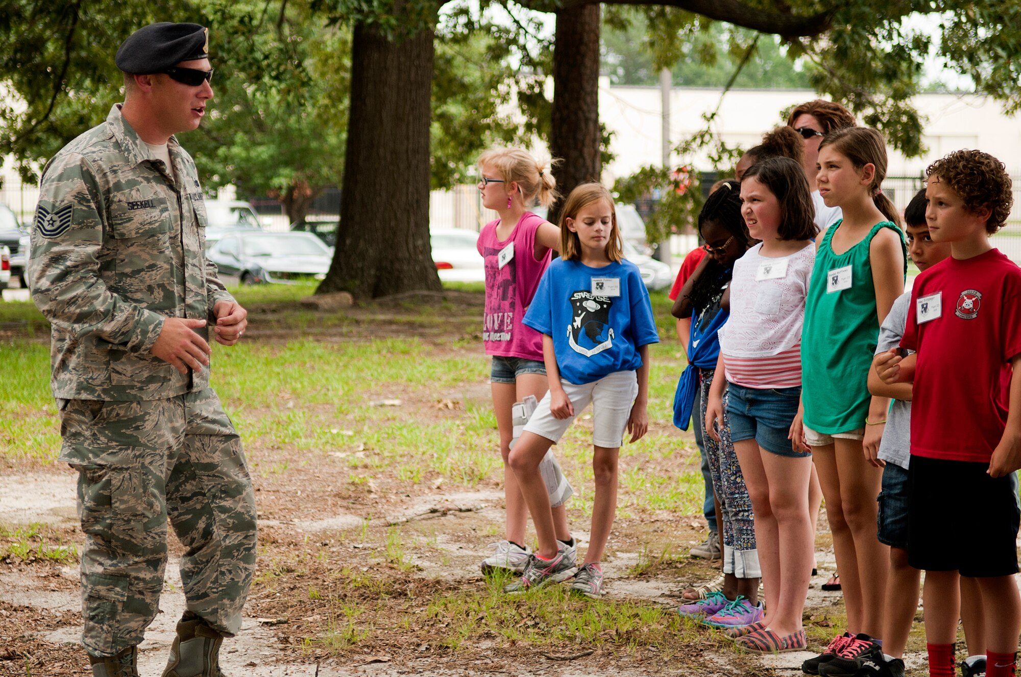 Tech. Sgt. Benjamin Seekell, 4th Security Forces Squadron kennel master, talks to the students from Seymour Johnson’s Science and Technology Academies Reinforcing Basic Aviation and Space Exploration (STARBASE) program about K-9, June 24, 2014, at Seymour Johnson Air Force Base, North Carolina. STARBASE is a collaborative effort between the base and the surrounding community to promote education and innovation. During the five-day program, local fifth-grade students study science, technology, engineering and mathematics disciplines beyond their current grade level. (U.S. Air Force photo/Airman 1st Class Shawna L. Keyes)