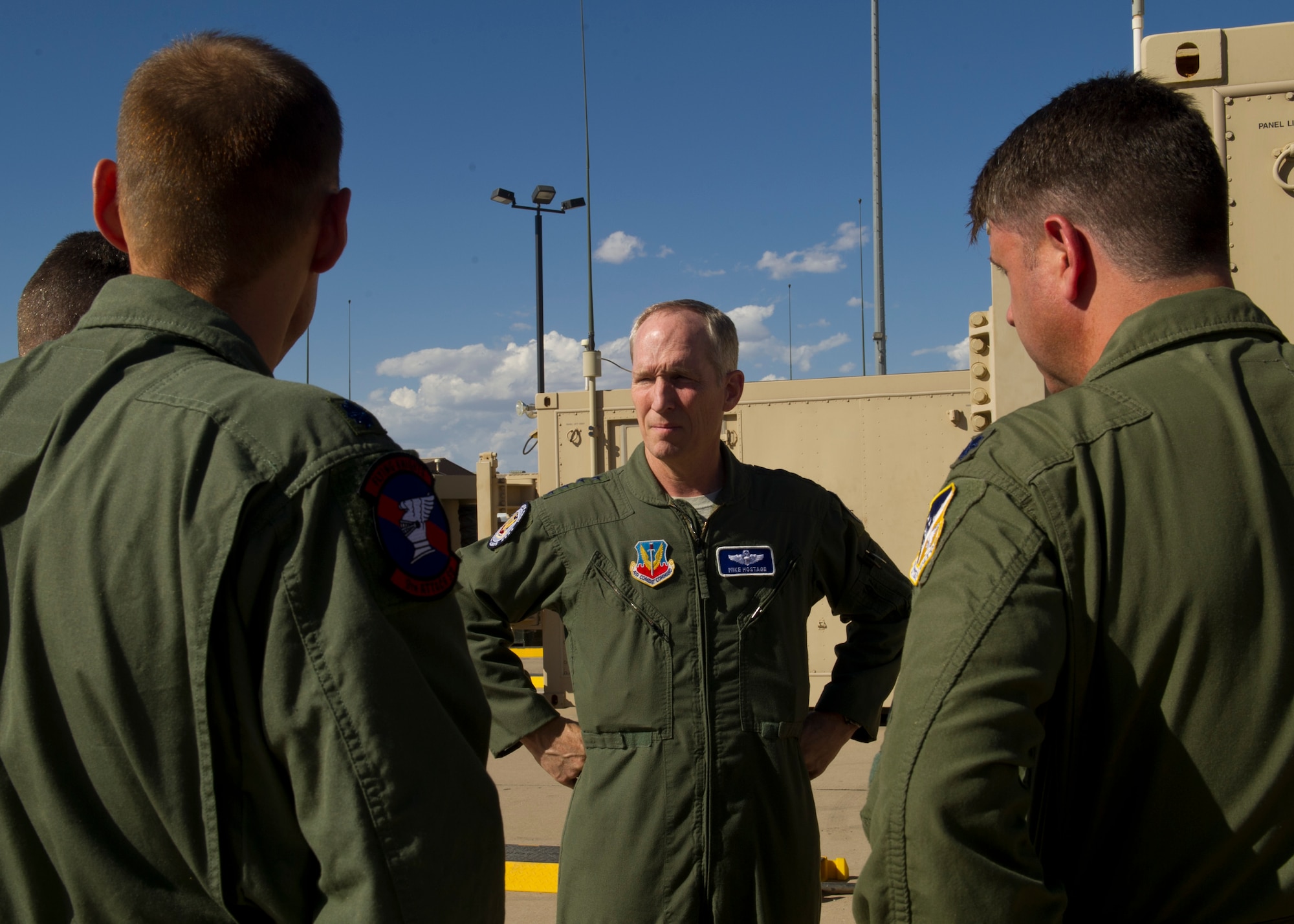 U.S. Air Force Gen. Mike Hostage, commander of Air Combat Command, observes the remotely piloted aircraft ground control stations during his tour at Holloman Air Force Base, N.M., June 25. Hostage visited the GCS farm to get a hands-on look at how sensor operators and pilots work together to conduct RPA training missions. (U.S. Air Force photo by Airman 1st Class Leah Ferrante/released) 