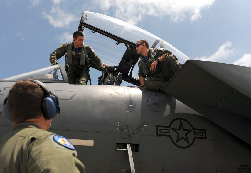 Capt. Rory “Maul” Klepper, a 334th Fighter Squadron pilot from Seymour Johnson Air Force Base, N.C., and Capt. Jared “Diablo” Thibault, 334th FS pilot exit their F-15E Strike Eagle, June 27, 2014, at McConnell Air Force Base, Kan. Thibault made a stop at McConnell to refuel and see brother, 1st Lt. Nathan Thibault, 349th Air Refueling Squadron navigator, and his family on the way to an air show at Hill Air Force Base, Utah. (U.S. Air Force photo/Airman 1st Class David Bernal Del Agua)