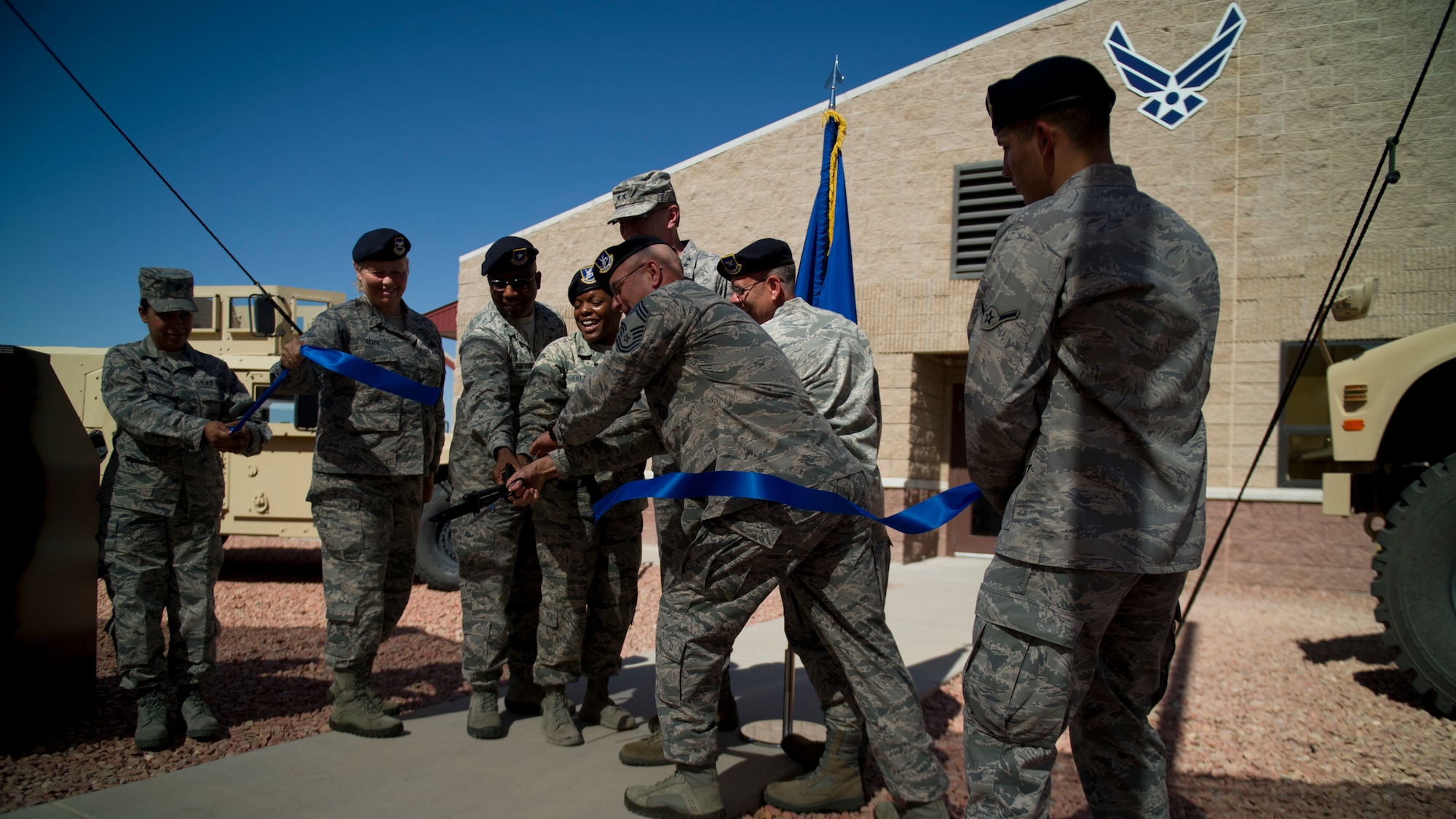 Leaders from the Ground Command Readiness Training Center cut the ribbon during the opening ceremony at Fort Bliss, Texas, June 26. The GCRTC consolidated a regional training center for all the military police personnel from both Air Force and Army to use to conduct required pre-deployment training. (U.S. Air Force photo by Airman 1st Class Aaron Montoya / Released)