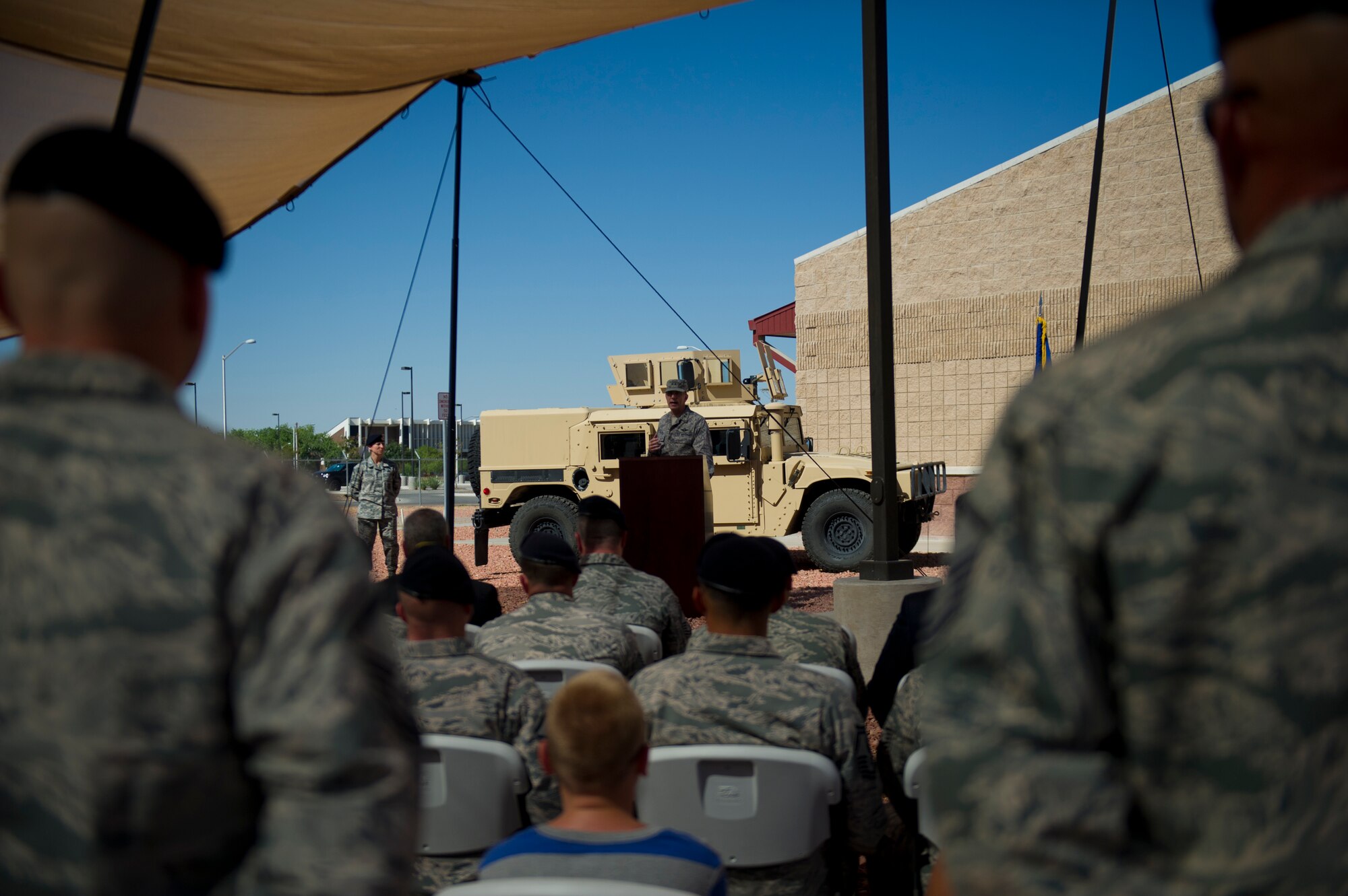 Major General Kenneth Wisian, deputy adjutant general of the Texas Air National Guard, addresses various military police personnel during the opening ceremony of the Ground Command Readiness Training Center assumption of command at Fort Bliss, Texas, June 26. The GCRTC consolidated a regional training center for all the military police personnel from both Air Force and Army to use to conduct required pre-deployment training. (U.S. Air Force photo by Airman 1st Class Aaron Montoya / Released)