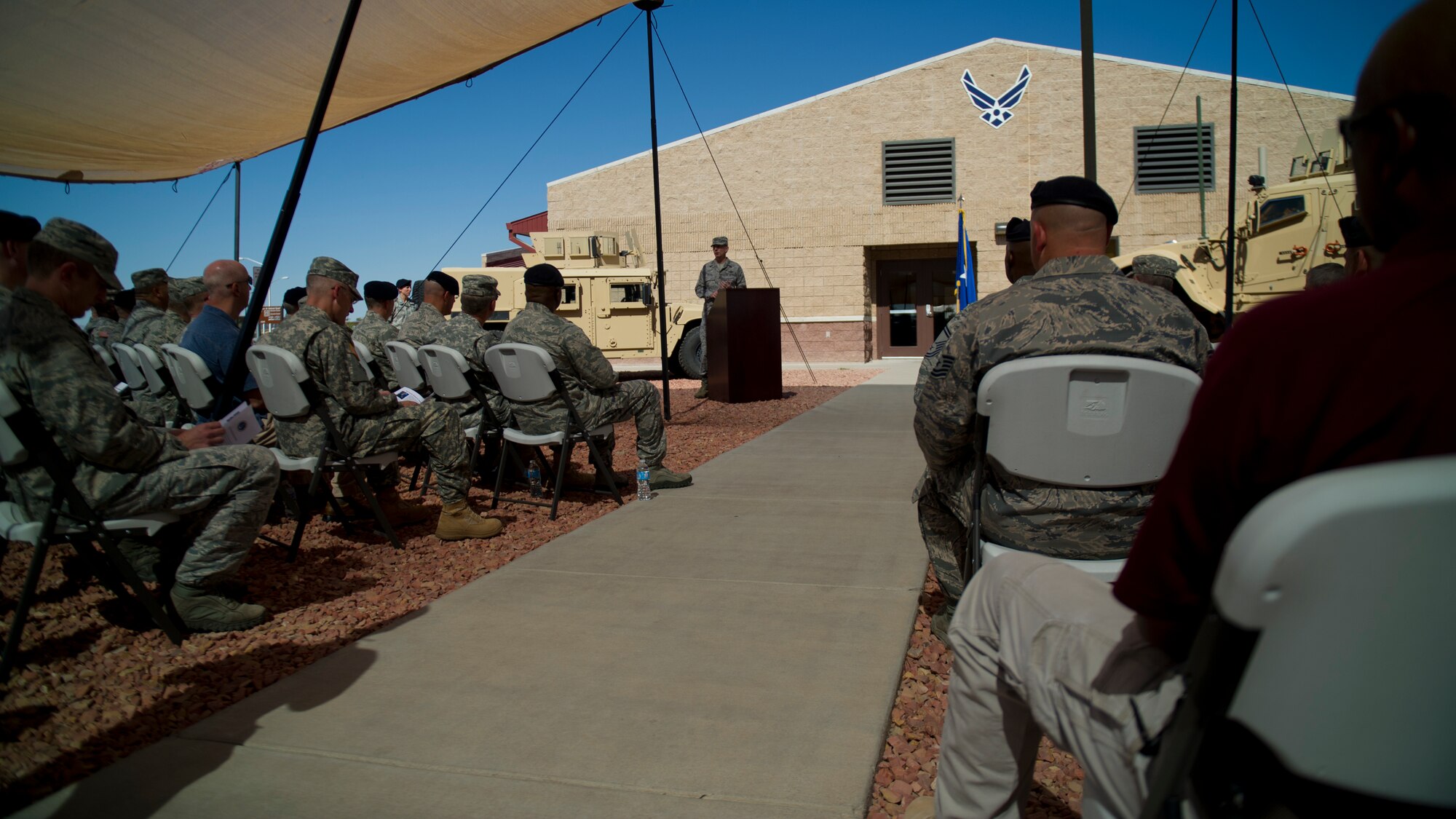 Major General Kenneth Wisian, deputy adjutant general of the Texas Air National Guard, addresses various military police personnel during the opening ceremony of the Ground Command Readiness Training Center assumption of command at Fort Bliss, Texas, June 26. The GCRTC consolidated a regional training center for all the military police personnel from both Air Force and Army to use to conduct required pre-deployment training. (U.S. Air Force photo by Airman 1st Class Aaron Montoya / Released)