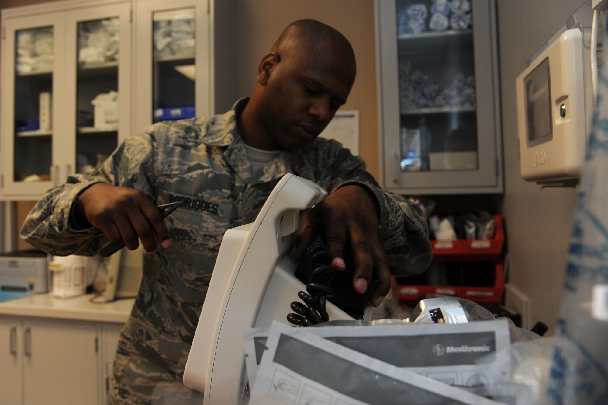 Tech. Sgt. Emanuel Rodrigues, the 19th Medical Support Squadron biomedical equipment maintenance noncommissioned officer in charge, inspects a defibrillator June 19, 2014, at Little Rock Air Force Base, Ark. Part of Rodrigues’ duties is to repair broken tools used during medical procedures. (U.S. Air Force photo by Airman 1st Class Mercedes Muro)