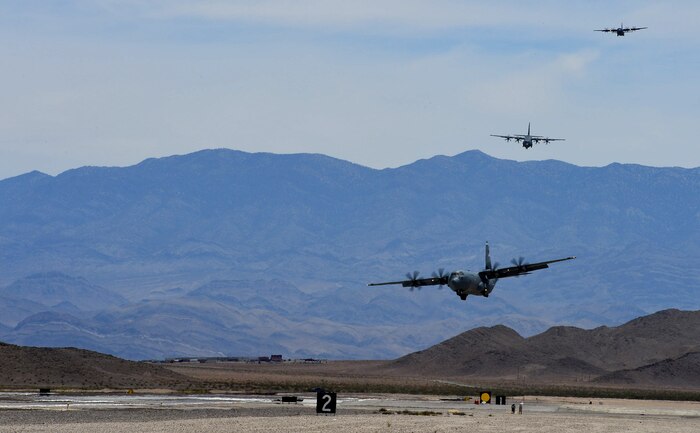 C-130J Super Hercules aircraft prepare to land at Creech Air Force Base, Nev., during Joint Forcible Entry June 21, 2014. The joint airdrop exercise is designed to enhance service cohesiveness between the U.S. Army and Air Force. It gives both services an opportunity to properly execute large scale heavy equipment and troop movement. (U.S. Air Force photo by Tech. Sgt. Nadine Barclay/Released)
