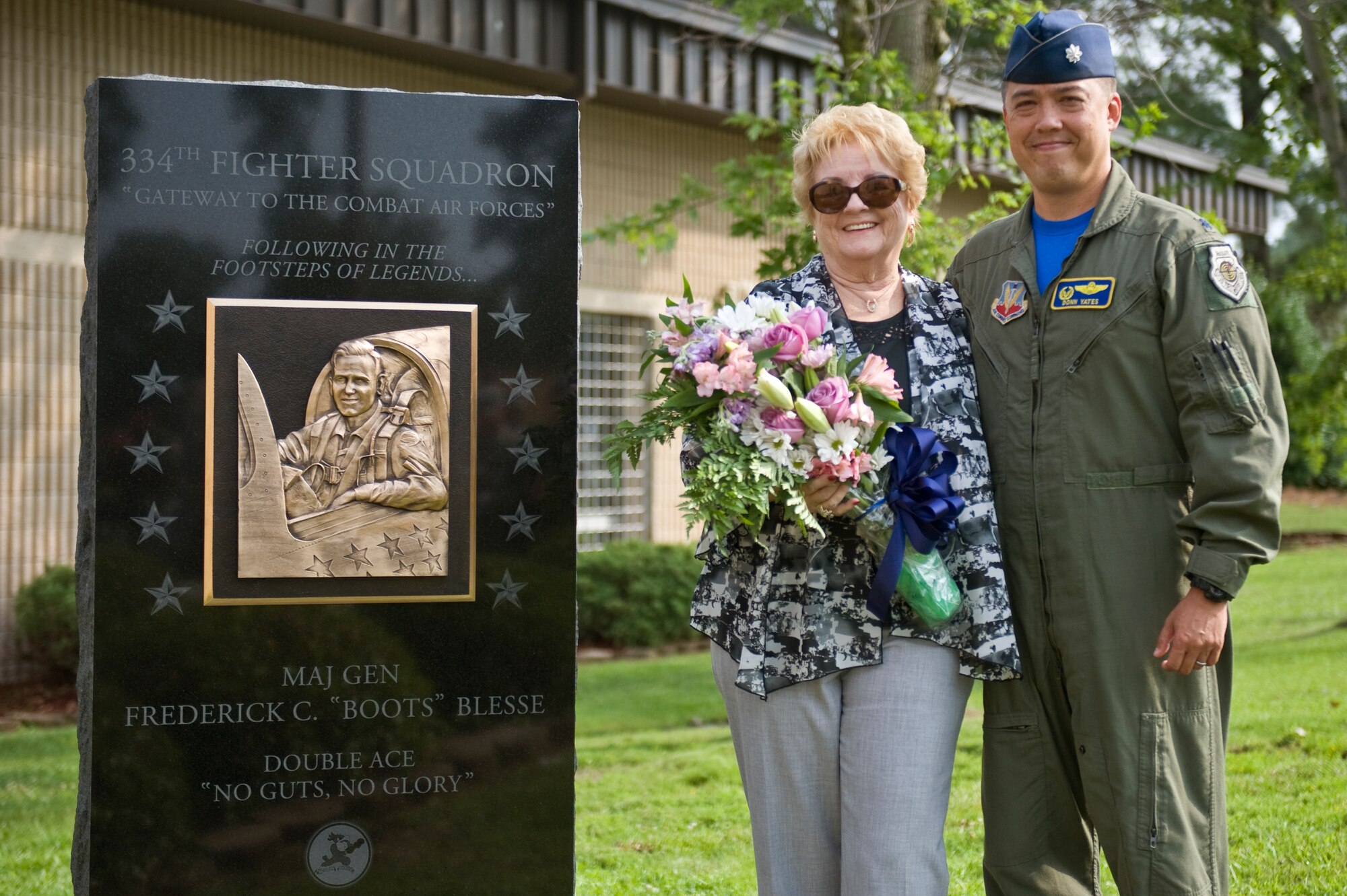 Betty Blesse, wife of late Maj. Gen. Frederick “Boots” Blesse, stands with Lt. Col. Donn Yates, 334th Fighter Squadron commander, after the unveiling of her late husband’s monument during a memorial dedication ceremony, June 27, 2014, at Seymour Johnson Air Force Base, North Carolina.  The memorial was constructed at the front of the 334th Fighter Squadron, the unit Blesse was assigned to when he recorded his tenth aerial kill.  (U.S. Air Force photo/Airman 1st Class Aaron J. Jenne)