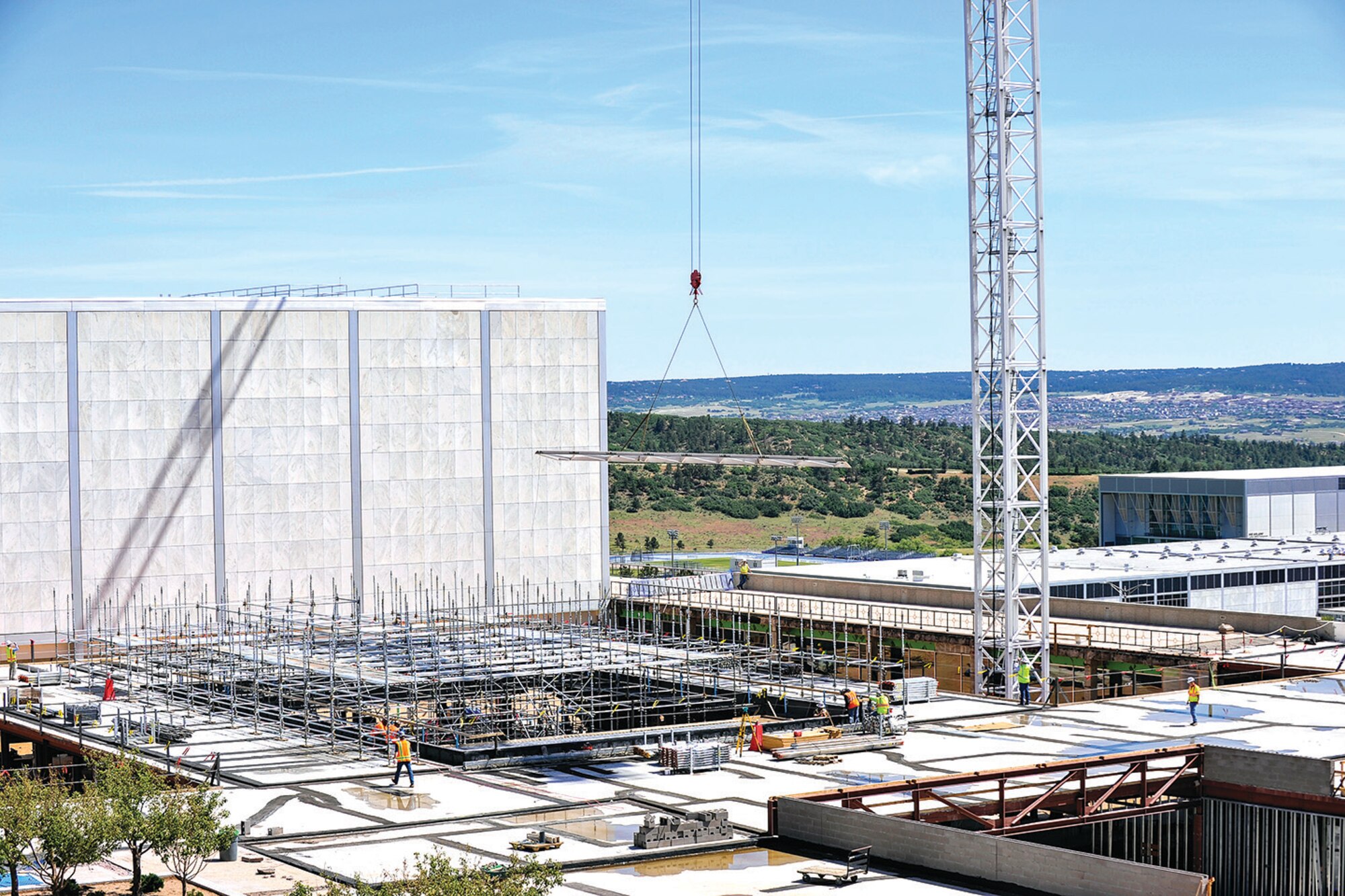 A crane lowers one of 72 steel trusses needed to assemble the skylight of the Center for Character and Leadership Development here. The first truss arrived at the Academy June 23. (Liz Copan/U.S. Air Force photo)