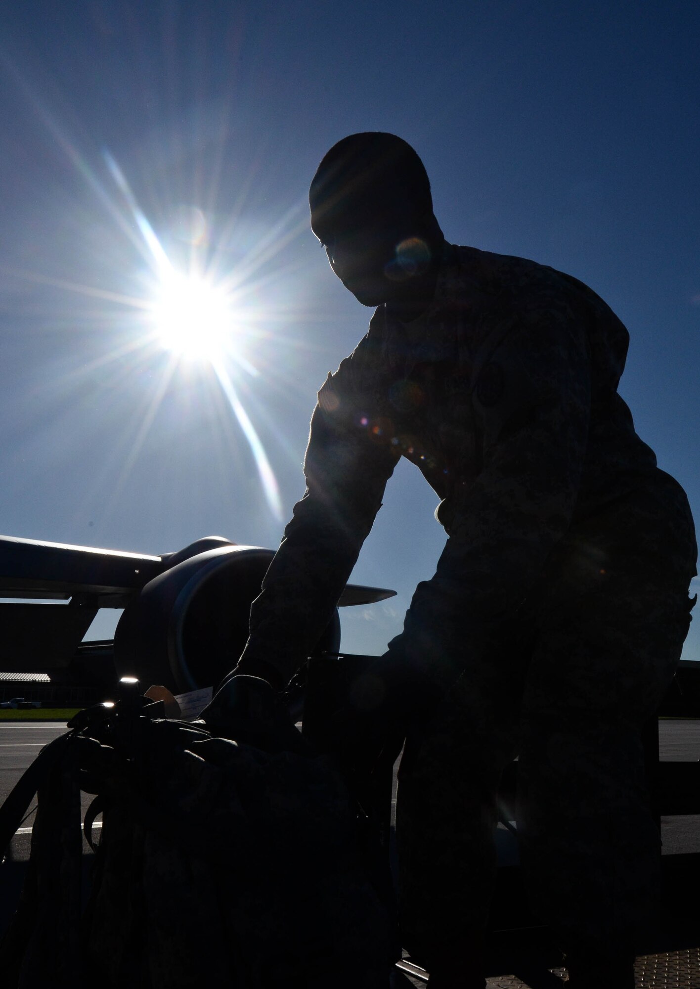 U.S. Army Spc. Joseph Cheeks, North Carolina National Guard 105th Military Police Battalion operations specialist, loads luggage into a KC-135 Stratotanker at Ellsworth Air Force Base, S.D., June 20, 2014 as part of the 2014 Golden Coyote exercise. The exercise provided firsthand experience to Airmen and the Guard with various real-world contingency exercises which strengthened mission effectiveness while building partnership capacity between the services. (U.S. Air Force photo by Senior Airman Zachary Hada/Released)